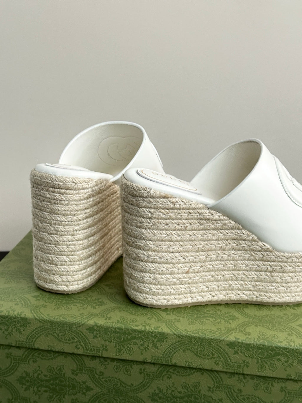 White Gucci platform slides heel view, showing woven wedge and cushioned interior