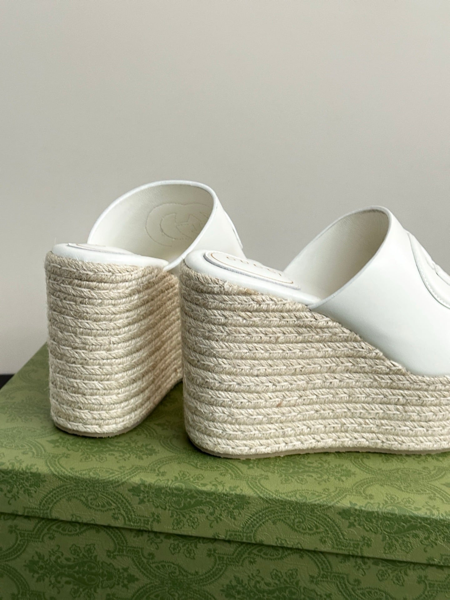 White Gucci platform slides heel view, showing woven wedge and cushioned interior