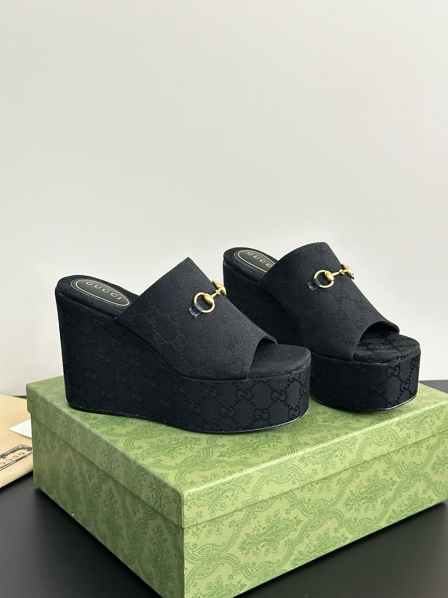 Gucci womens luxury shoes, dark wedge slide mules with gold horsebit on straps