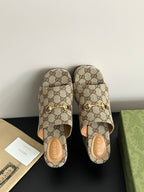 Gucci ladies’ GG canvas platform slides with gold horsebit ornament and cushioned footbed