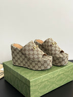 Gucci ladies’ GG canvas platform slides with gold horsebit accent and tan interior lining