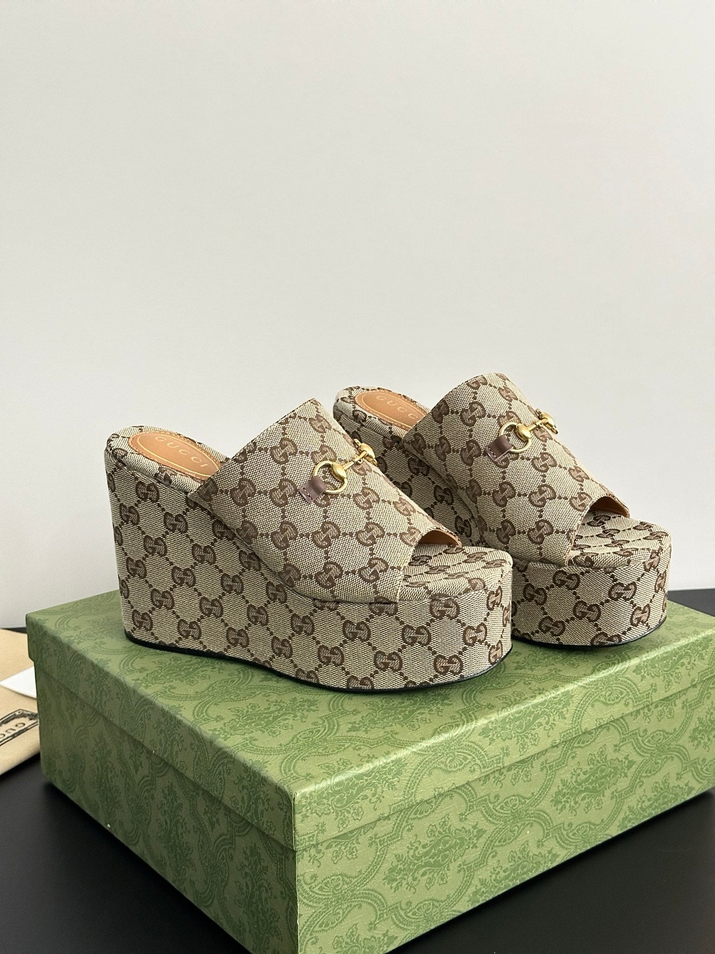 Gucci ladies’ GG canvas platform slides with gold horsebit accent and tan interior lining