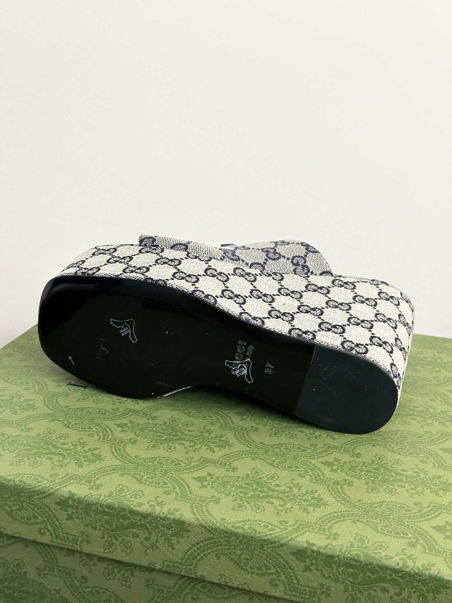 Gucci GG-print platform slide sandals, outsole view with open-toe profile.