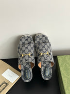 Gucci GG-print platform slide sandals with gold buckle straps, open toe and back view.