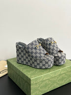 Gucci GG-print platform slide sandals with gold-tone buckle detail, side view.
