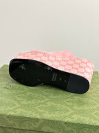 Pink Gucci platform sandals with GG monogram upper and black rubber outsole.