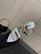 Women's silver heeled sandal shown from side, pointed toe and open straps