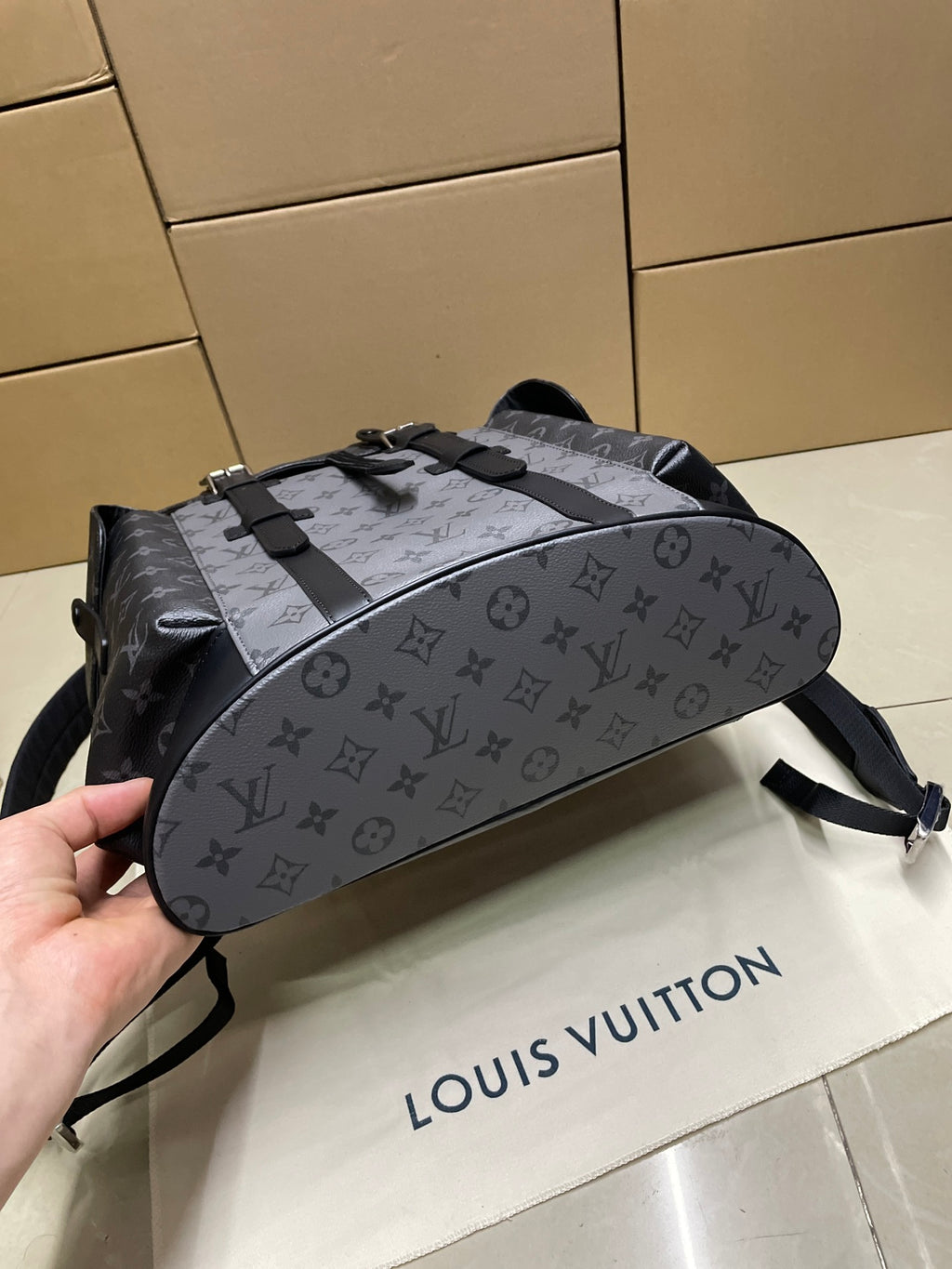 Louis Vuitton monogram backpack with side strap detail, dark gray