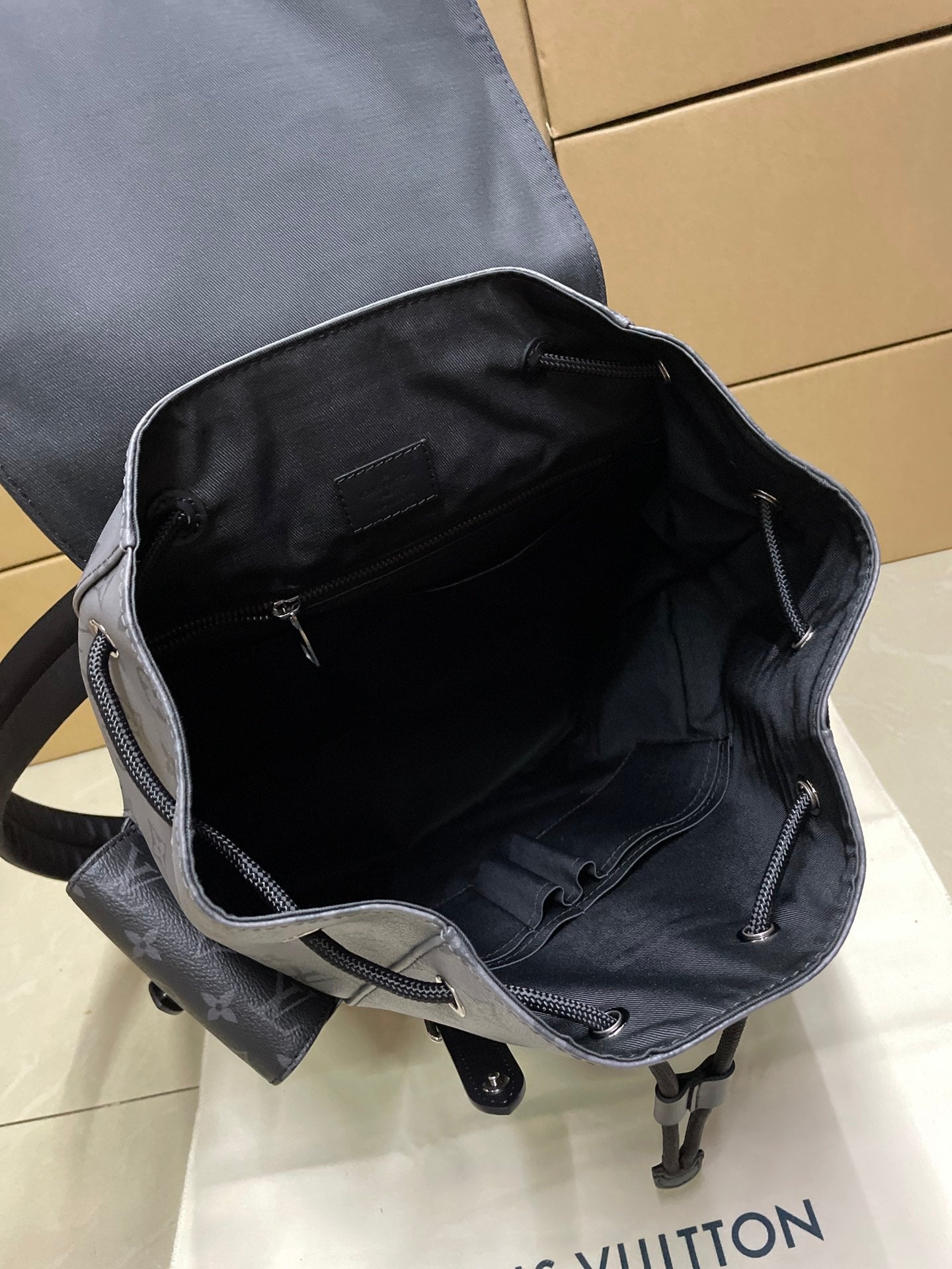 Backpack interior view with open top, dark lining, and zipper closure at edge
