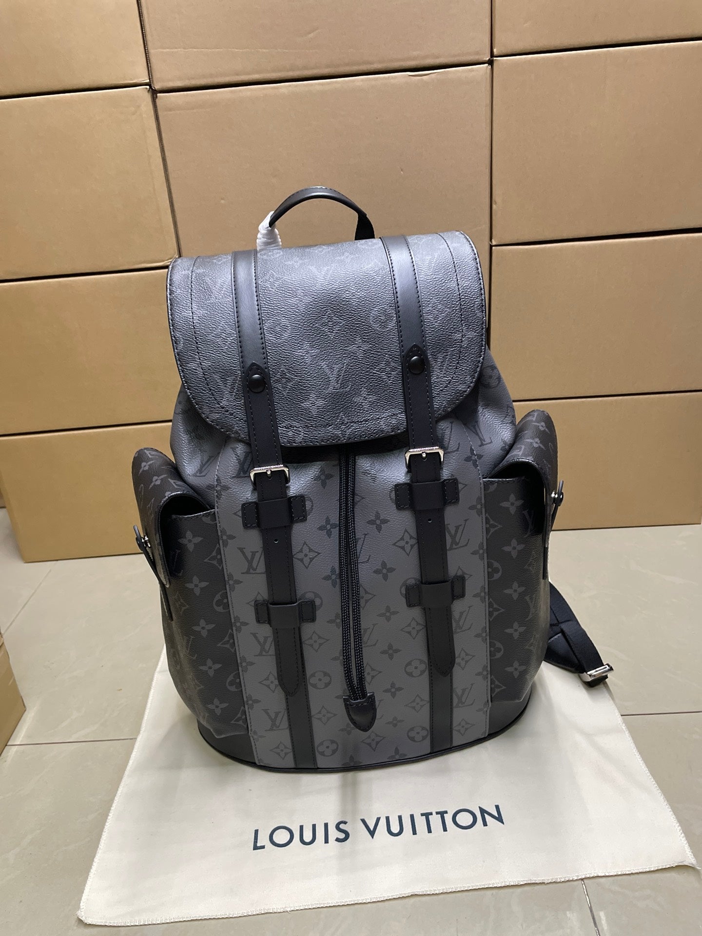 Louis Vuitton monogram backpack with flap, top handle, and black strap details