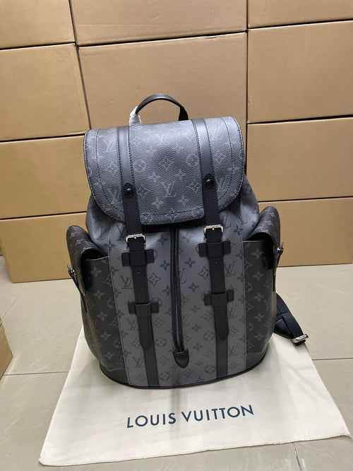 Louis Vuitton monogram backpack with flap, top handle, and black strap details