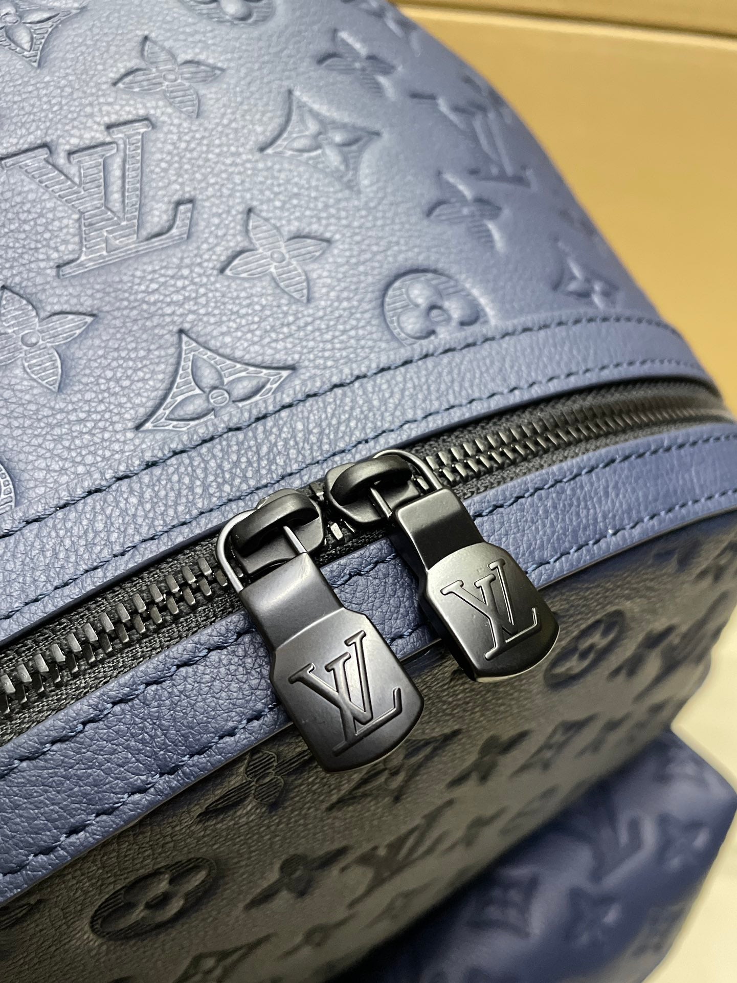 Louis Vuitton monogram backpack close-up of dark strap buckle and zipper hardware