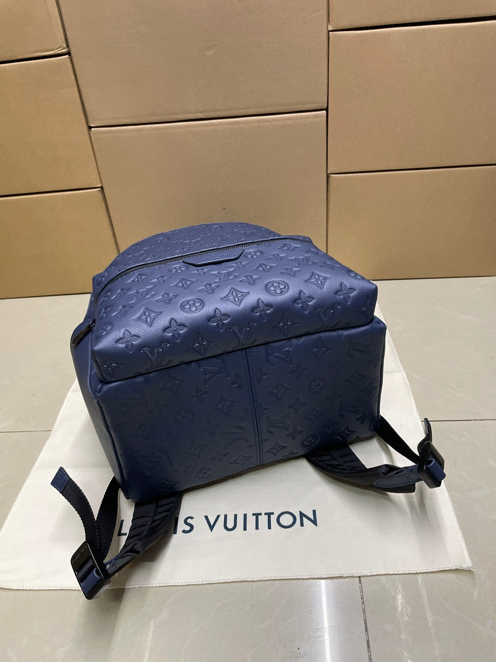 Navy monogram mini backpack with top panel and front zipper closure