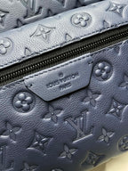 Louis Vuitton monogram backpack close-up of navy leather texture and zipper pull tab