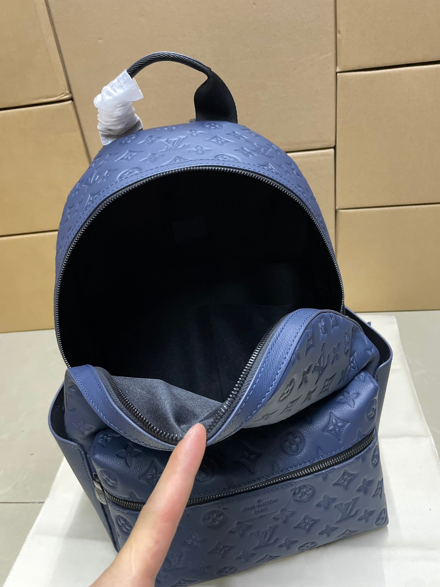 Blue monogram mini backpack open view showing dark fabric lining