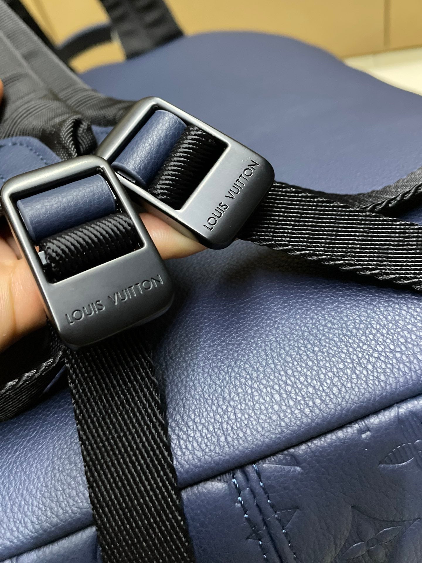 Blue leather strap with metal buckle and woven webbing