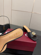 Black mule sandal with beige insole and gold-tone GG buckle detail