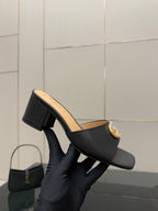 Black mule sandal with gold-tone GG buckle and chunky block heel