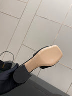 Black mule sandal with beige insole and black strap detail