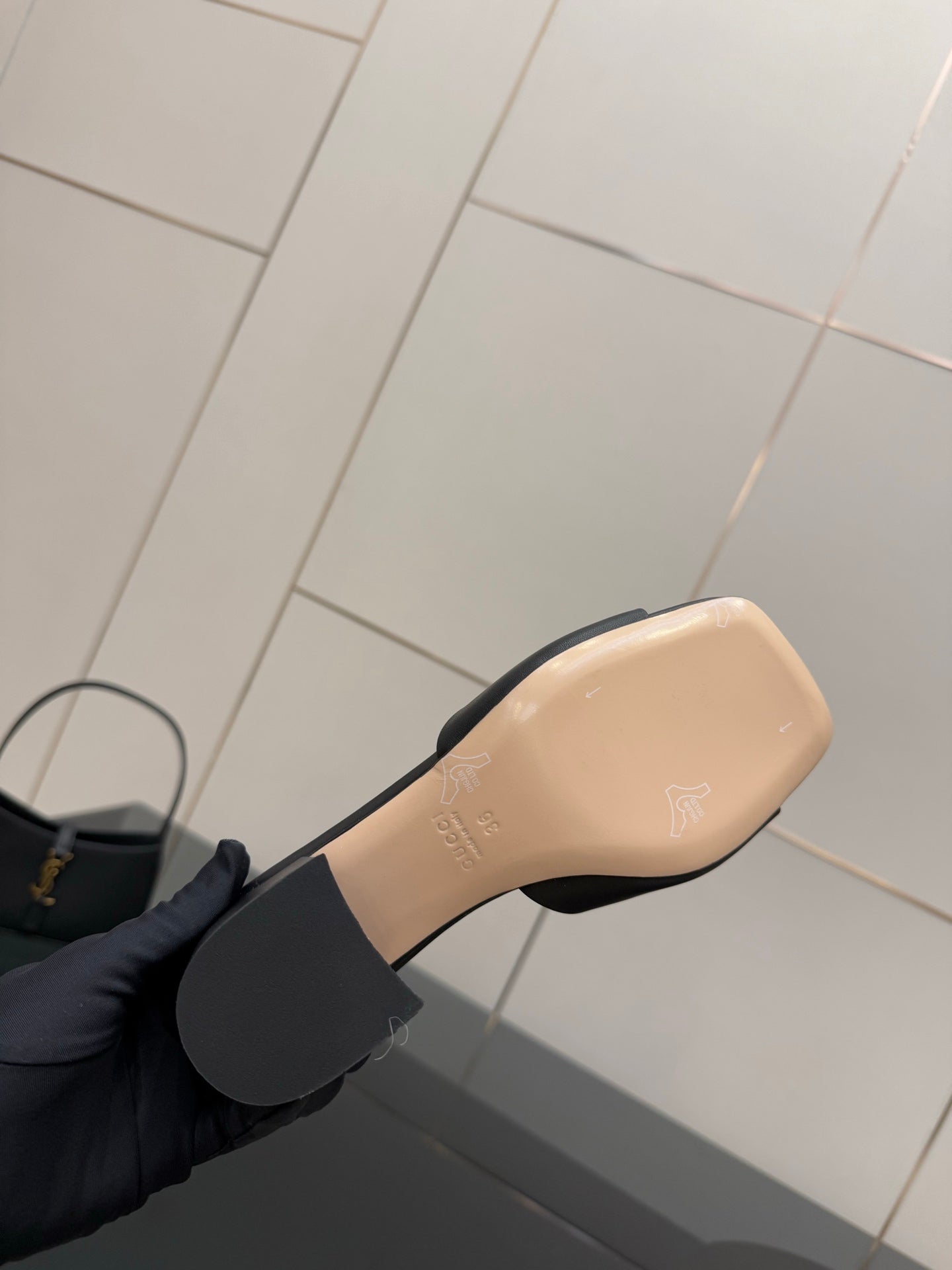 Black mule sandal with beige insole and black strap detail