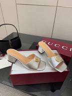 Gucci women's silver slide mules with gold logo detail and low block heel
