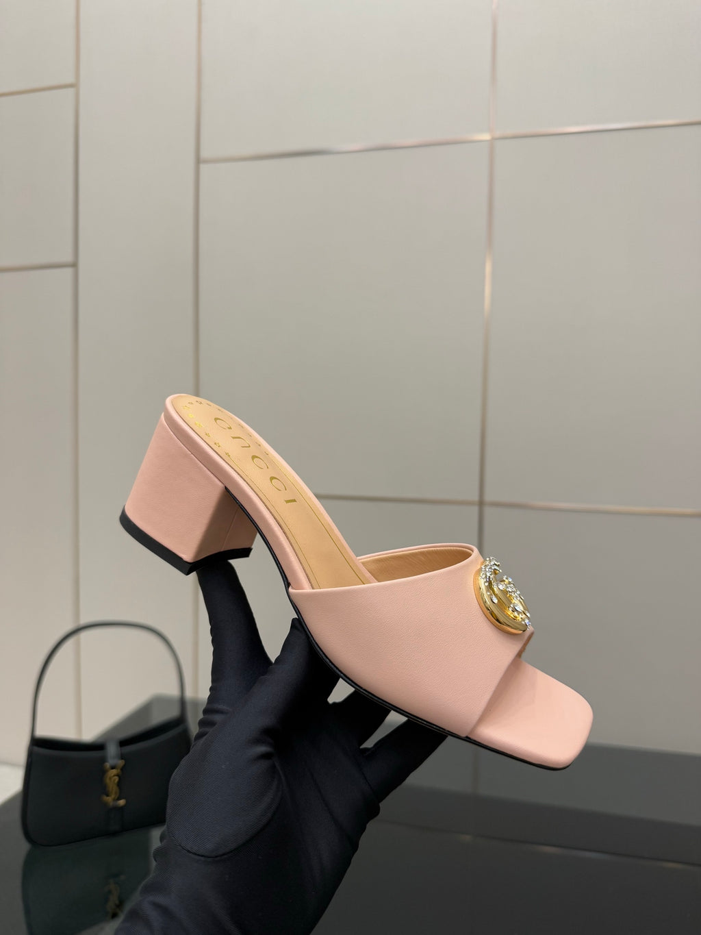 Women’s pink slide mule with square heel and gold logo ornament on the toe strap