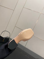 Women’s pink mule sandal with gold logo emblem and low block heel