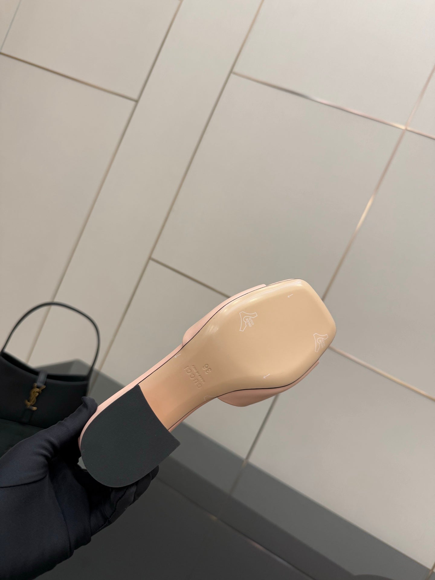 Women’s pink mule sandal with gold logo emblem and low block heel