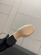 Gucci ladies cream mule outsole view with gold-tone lettering, heel area close-up