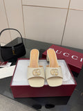 Gucci ladies cream mules with gold-tone logo buckle on a low block heel