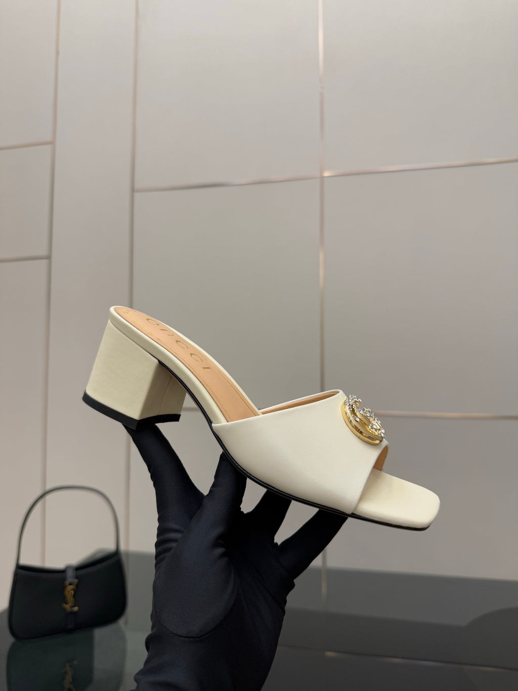 Gucci ladies cream mules with gold-tone logo buckle, side view on block heel