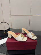 Gucci ladies cream mules with gold-tone logo buckle and low block heels, pair shown