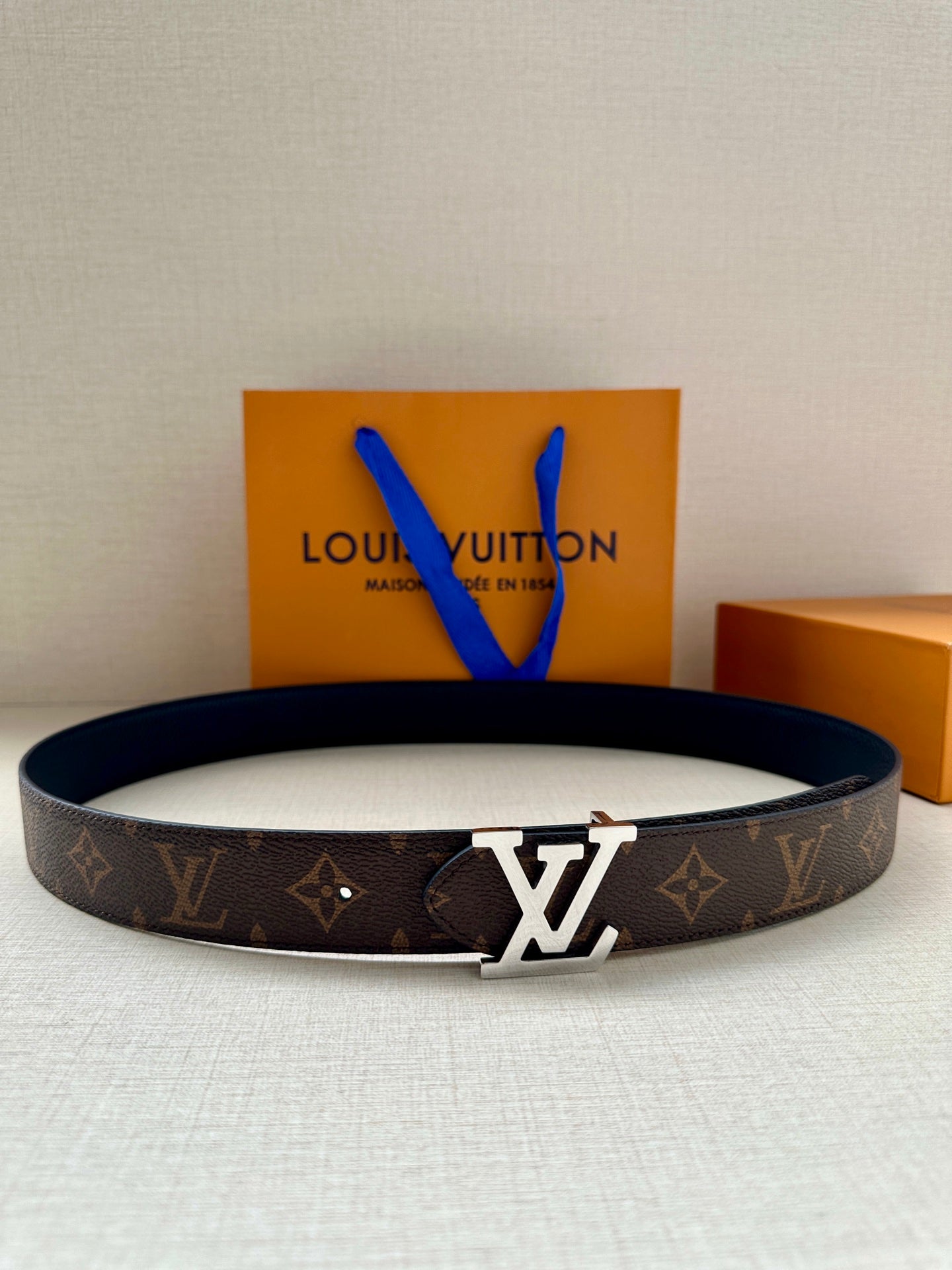Brown monogram canvas belt with gold-tone LV buckle and dark lining strap