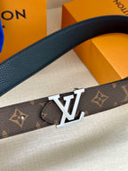 Dark monogram belt with gold-tone LV buckle close-up on textured strap