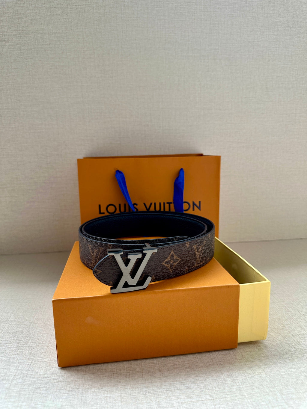 Monogram canvas belt with oversized gold-tone LV buckle on box