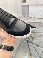 Burberry sneaker toe and laces close-up, black leather with textured rubber rand