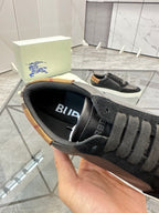 Burberry sneaker interior view, black insole with blue “BURBERRY” lettering