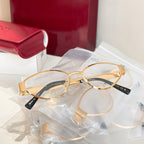 Two gold round eyeglasses with clear lenses and black temple arms.