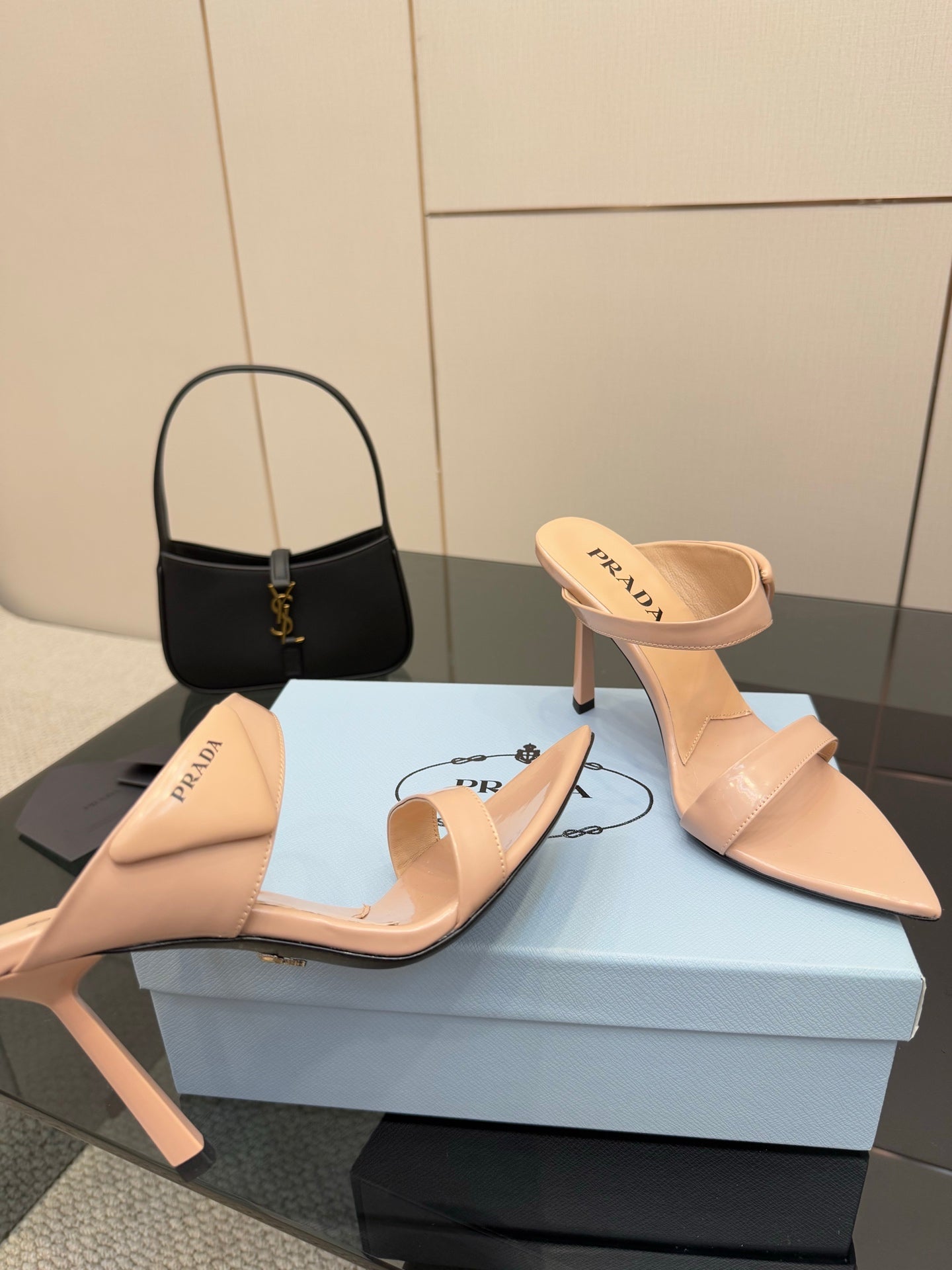 Prada women’s light beige mules with stiletto heels, angled front view pair