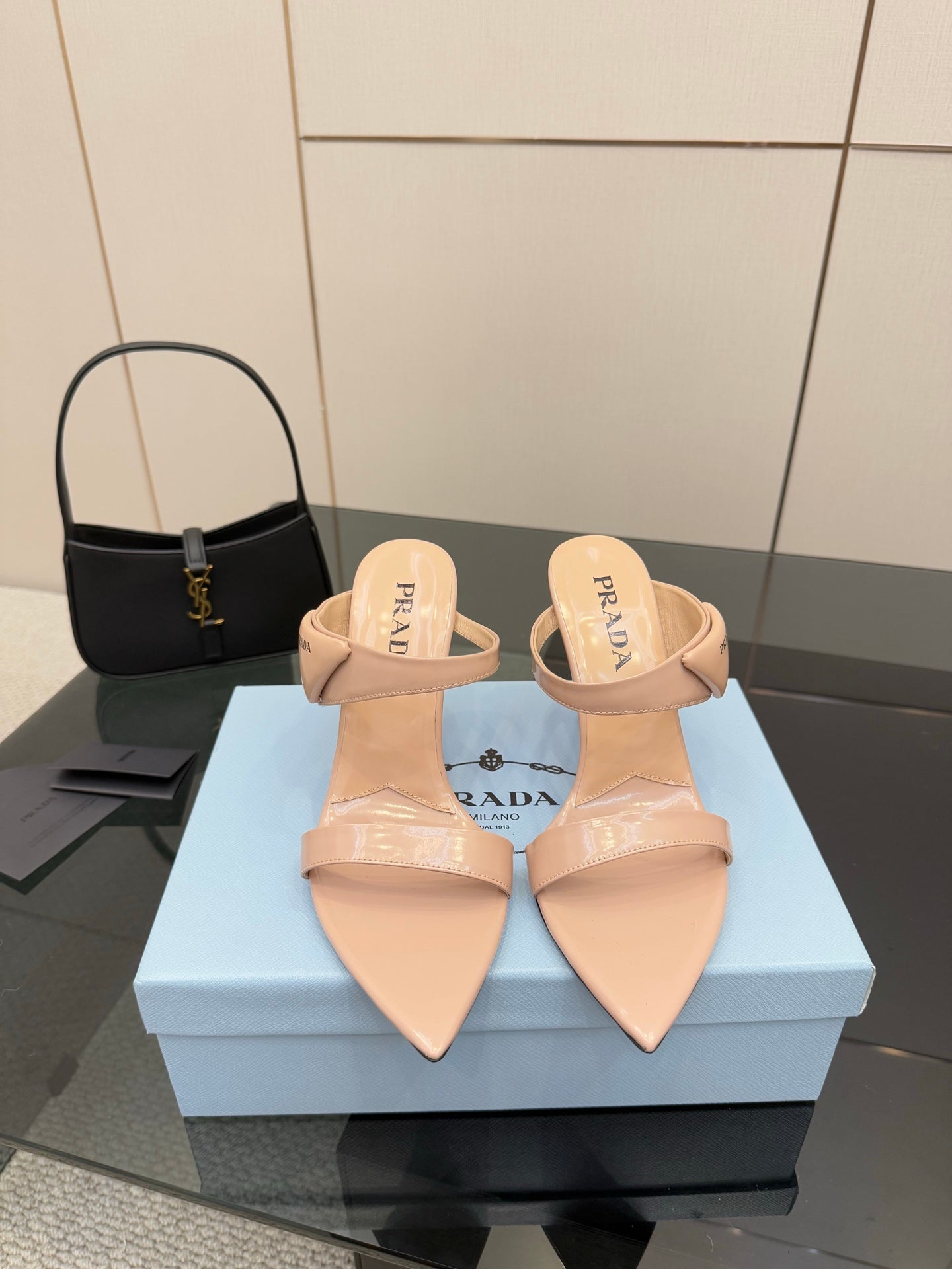 Prada women’s light beige heeled mules, pointed toe, pair on display