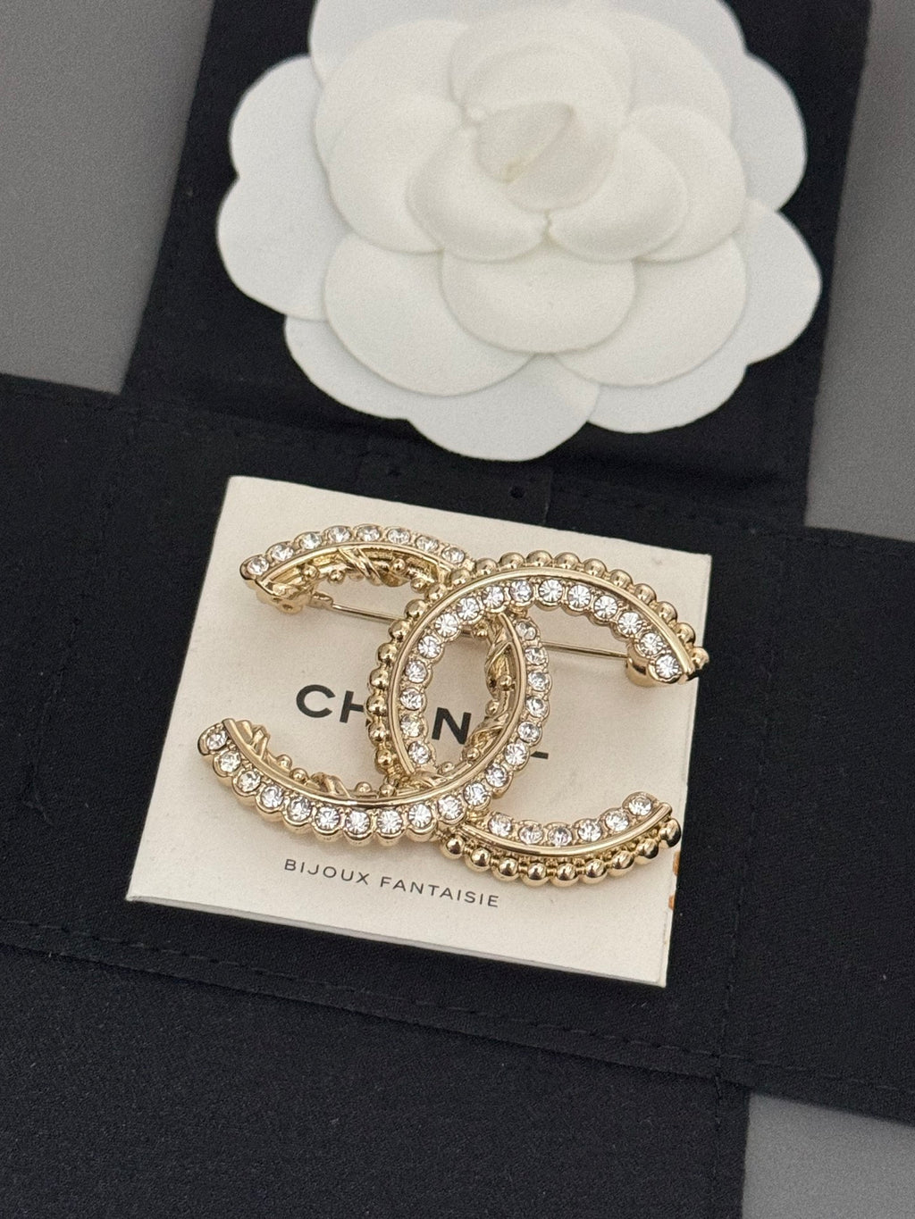 Gold-tone rhinestone Chanel brooch, oval C charm with bead-like trim
