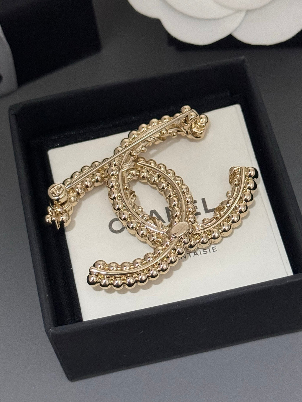 Gold-tone rhinestone Chanel brooch with looping oval C and bead trim