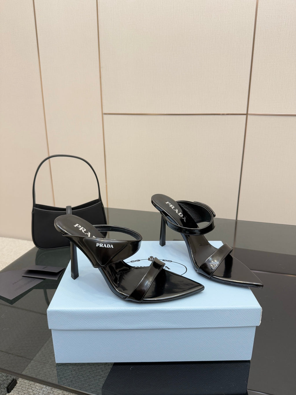 Prada black patent heeled mules with open toe and logo strap