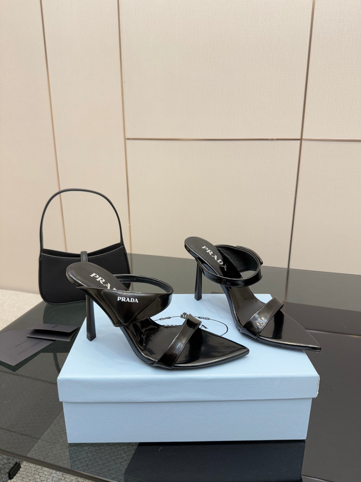 Prada black patent heeled mules with open toe and logo strap