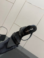 Prada black mule sandal close-up of logo insole and strap