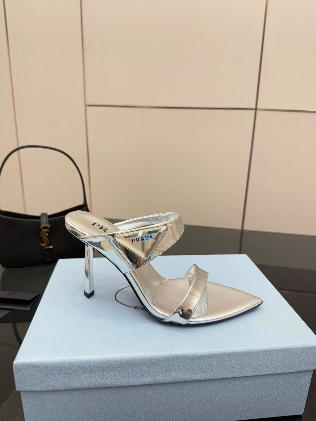Women's silver heeled mule sandal with pointed toe and reflective strap