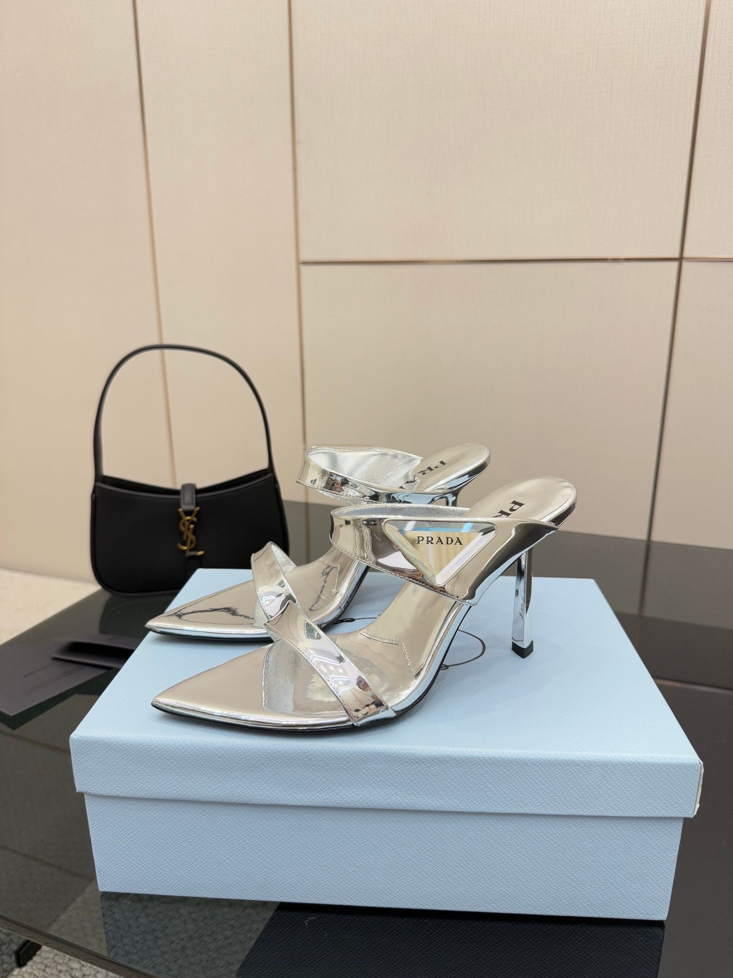 Women's silver heeled sandals with open cutouts and slim high heel