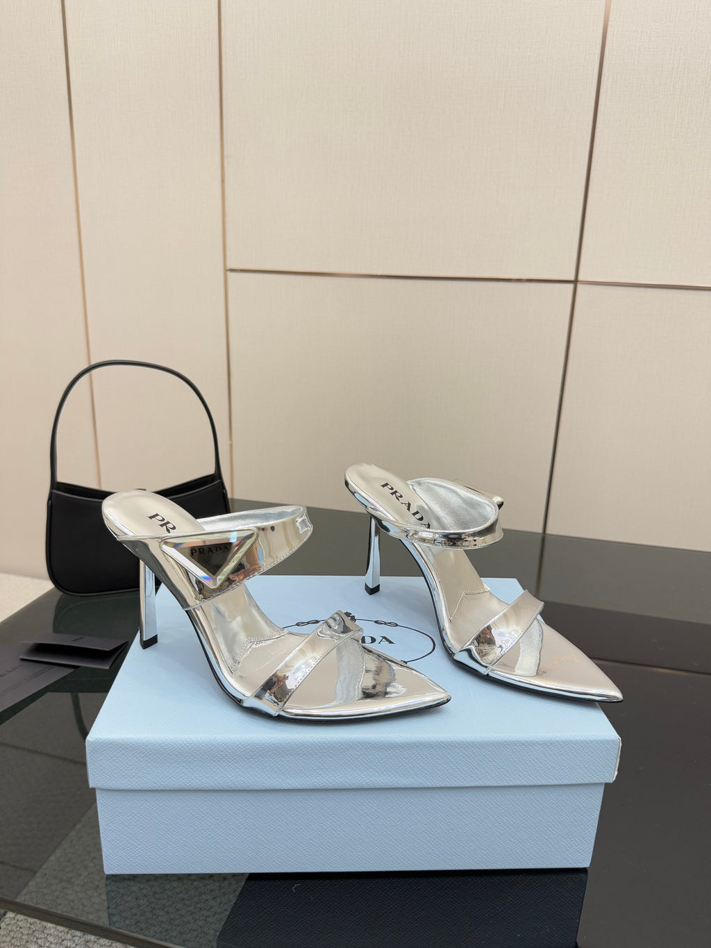 Women's silver pointed-toe heeled mules with ankle-strap style cutouts