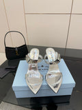 Women's silver heeled sandals with pointed toe and clear strap details