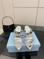 Women's silver heeled sandals with pointed toe and clear strap details